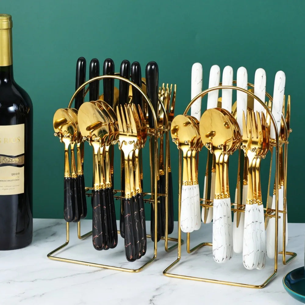Stainless steel flatware set by MC THE BLACK DIAMOND, includes forks, knives, and spoons arranged on a table.