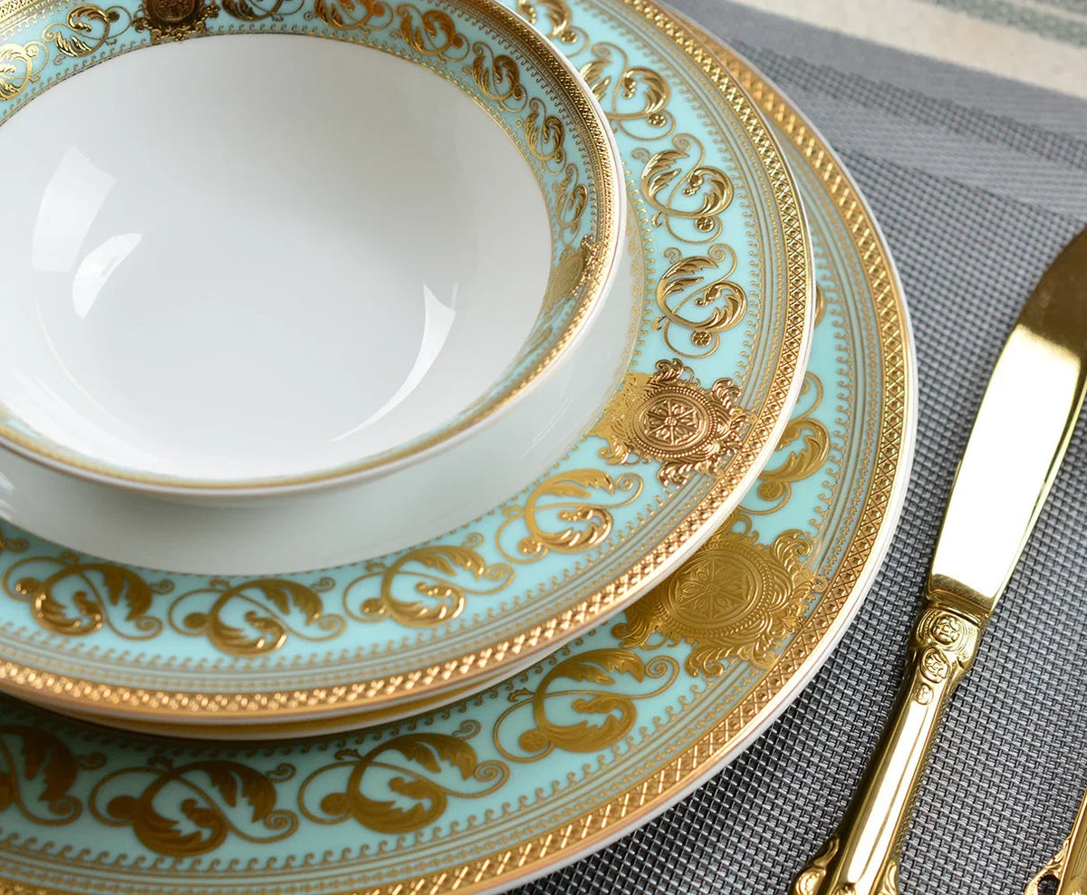 Embossed gold porcelain dinnerware set by MC THE BLACK DIAMOND, featuring elegant plates and bowls with intricate embossed designs.