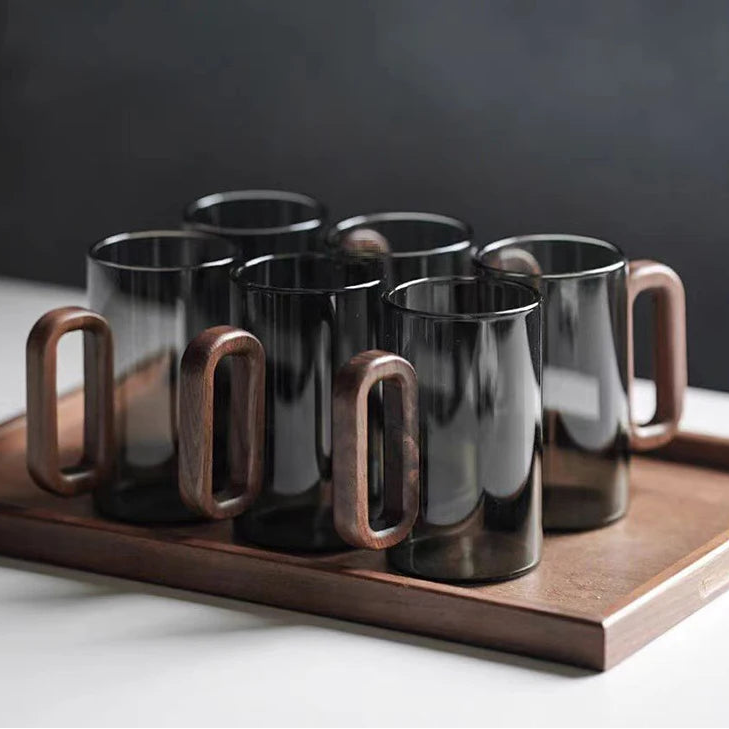 Glass mug with wooden handle from MC The Black Diamond drinkware set, showcasing a stylish and heat-resistant design.
