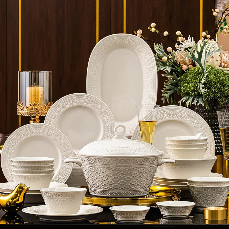 Set of elegant ceramic luxury dinnerware by MC THE BLACK DIAMOND, includes plates and bowls arranged on a stylish table.