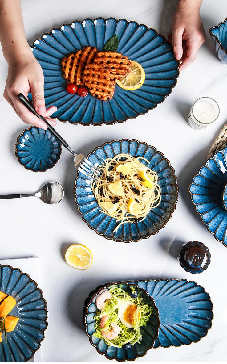 Western dinnerware set by MC THE BLACK DIAMOND featuring kiln-variable glazed plates and bowls on a table setting.