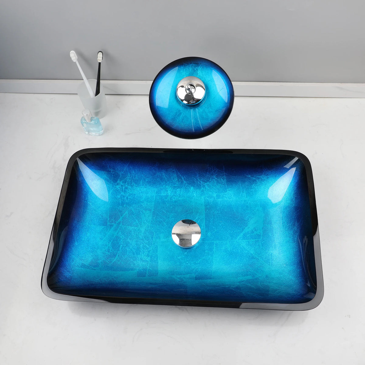 Blue glass vessel sink with waterfall faucet set by MC THE BLACK DIAMOND, modern bathroom fixture with sleek design and water flow feature.