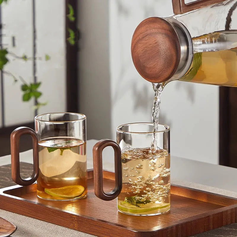 Glass mug with wooden handle from MC The Black Diamond drinkware set, showcasing a stylish heat-resistant design.