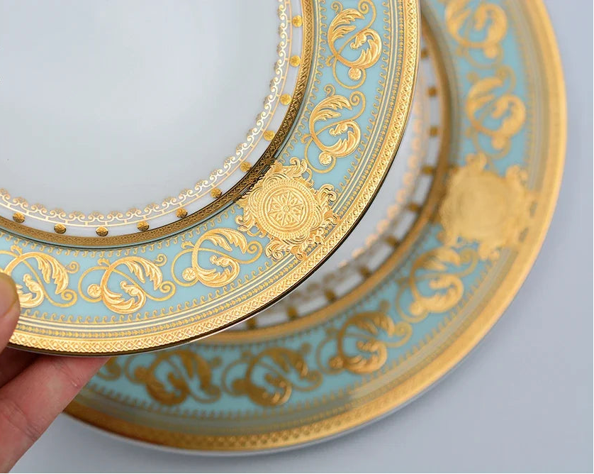 Embossed gold porcelain dinnerware set by MC THE BLACK DIAMOND with elegant luxury design and intricate embossed patterns.