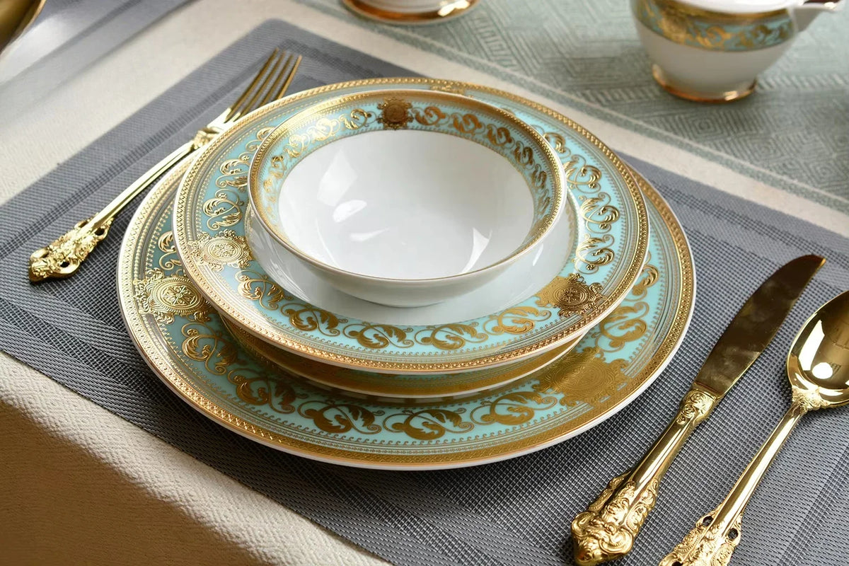 Embossed gold porcelain dinnerware set by MC THE BLACK DIAMOND, featuring elegant plates and bowls with luxurious gold detailing.