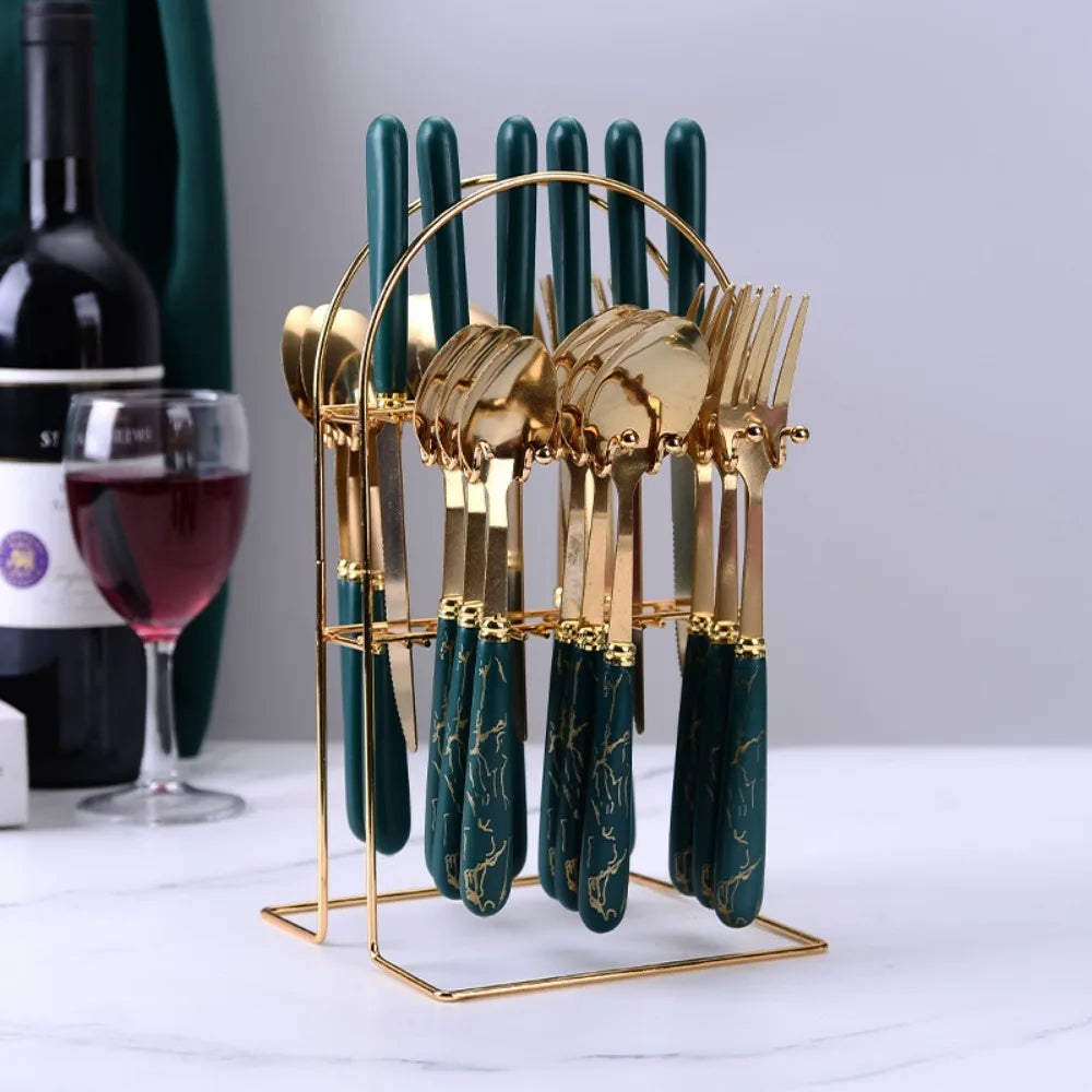 Stainless steel flatware set by MC THE BLACK DIAMOND, includes knives, forks, and spoons arranged on a table.