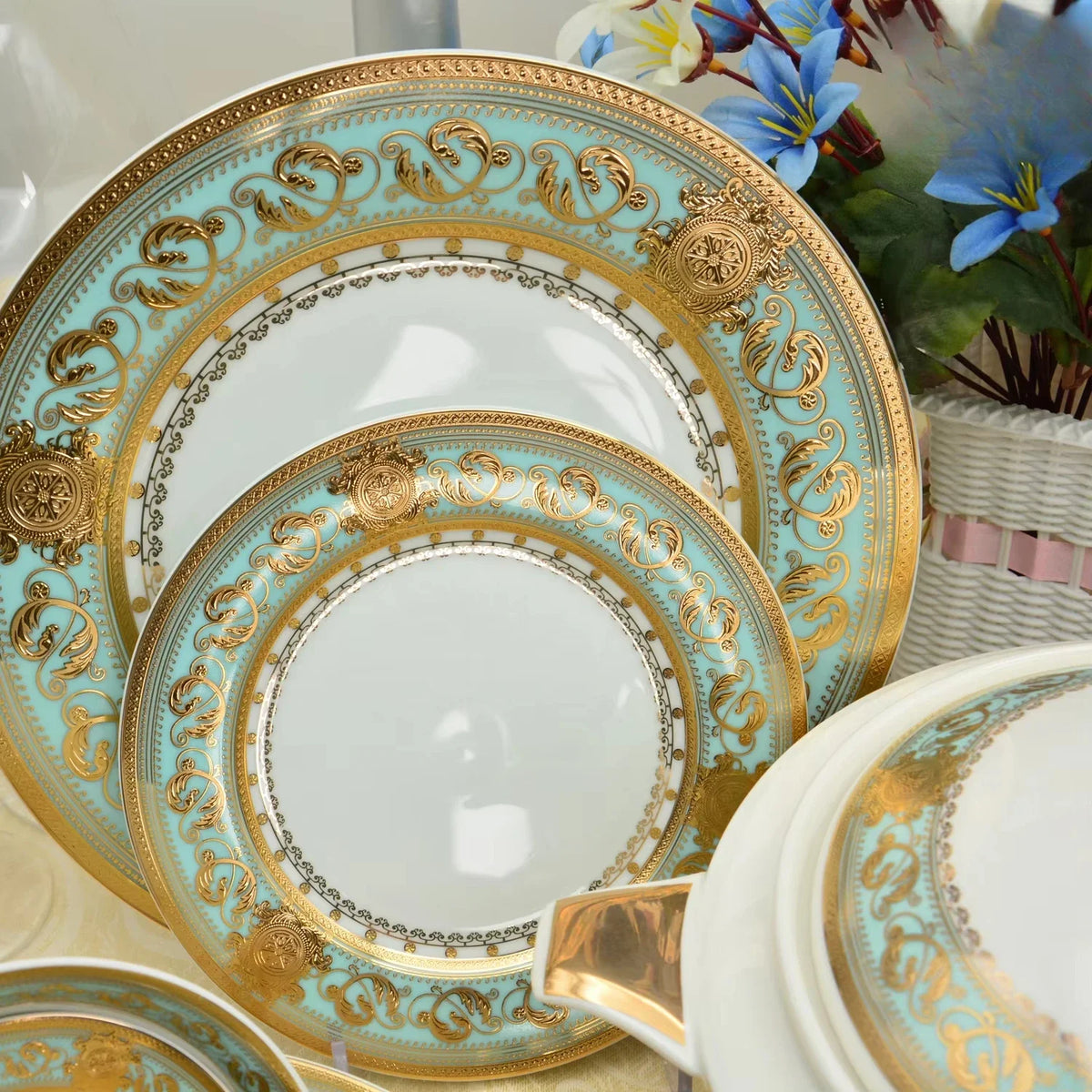 Gold embossed porcelain dinnerware set by MC THE BLACK DIAMOND, featuring elegant plates and bowls with intricate designs.