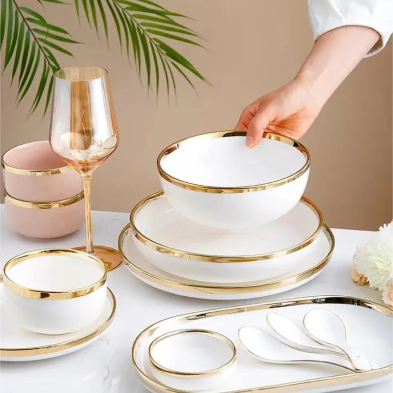 Set of bright white, pink, and gold porcelain kitchen plates by MC The Black Diamond, featuring elegant and decorative dinnerware.