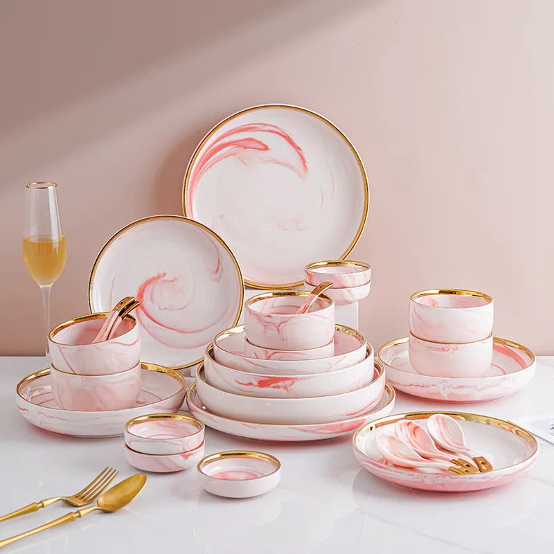 Pink gilded marble pattern porcelain dinnerware set by MC THE BLACK DIAMOND, featuring elegant plates and bowls with gold accents.
