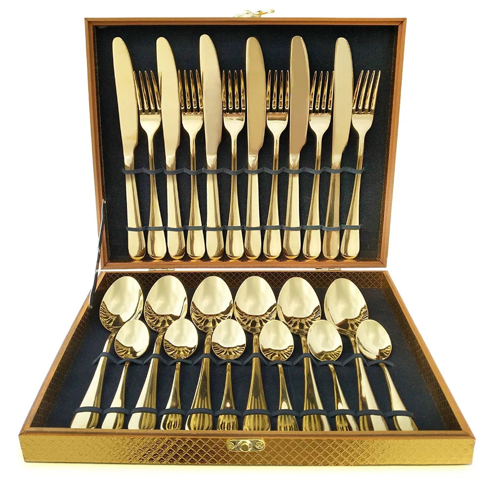 MC THE BLACK DIAMOND golden flatware set with cutlery dishes, featuring sleek, polished utensils arranged on a clean surface.