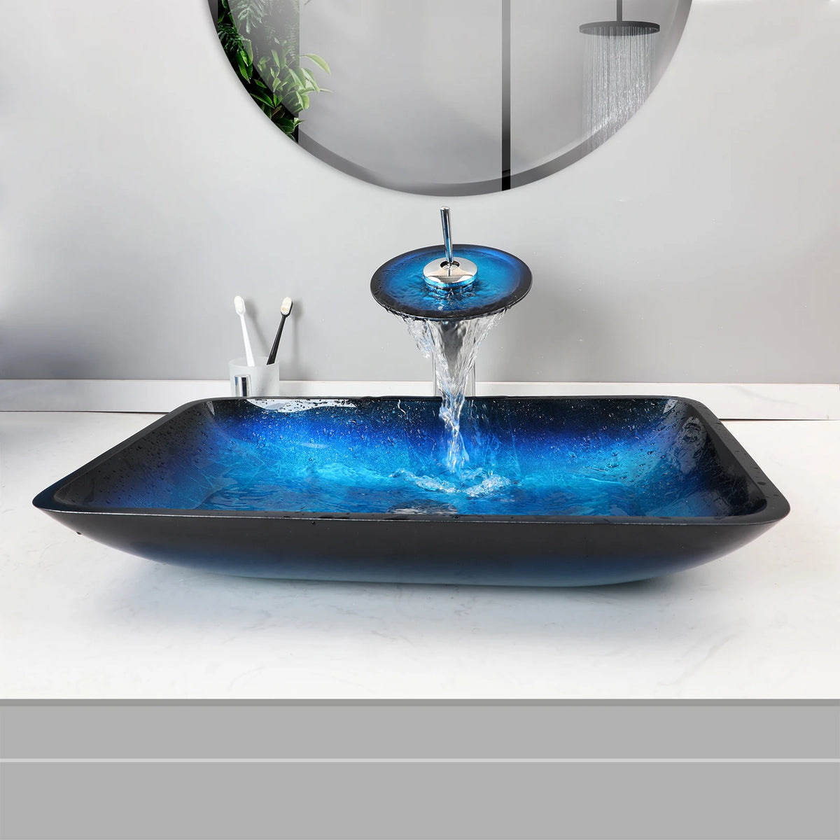 Blue glass vessel sink with waterfall faucet set by MC THE BLACK DIAMOND, showcasing sleek design and modern bathroom fixture.