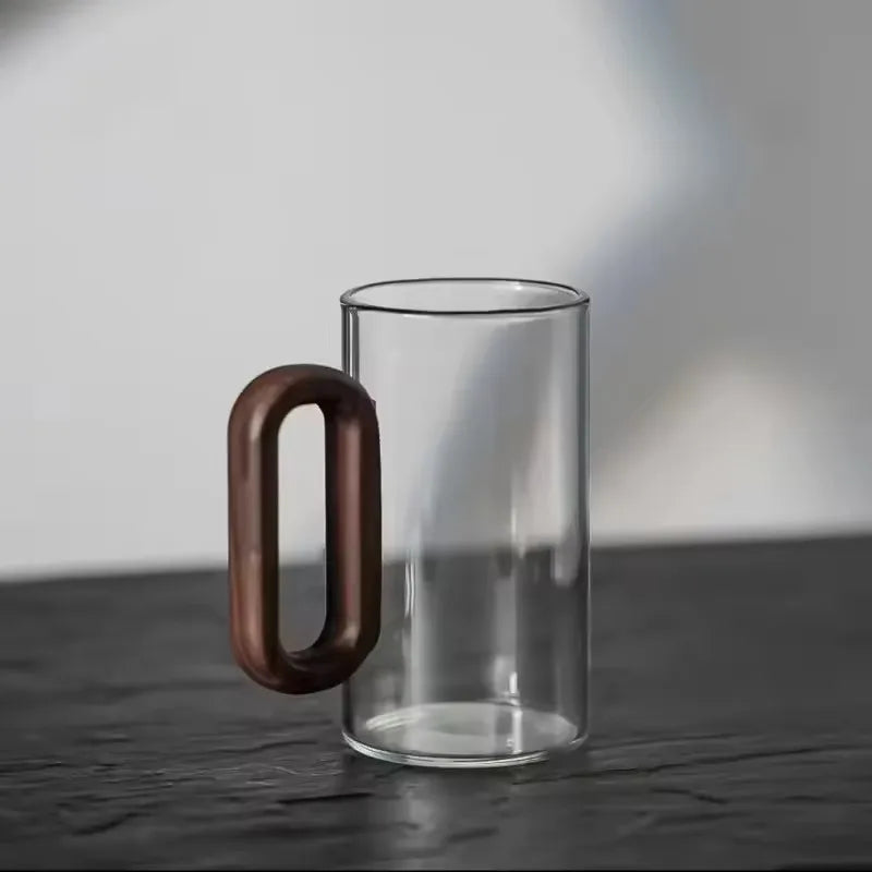 Glass mug with wooden handle from MC The Black Diamond drinkware set, designed for hot beverages, showcasing a clear glass and wooden grip.