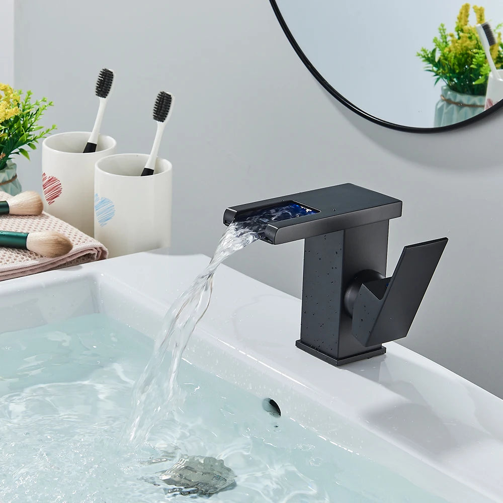 Black LED bathroom sink faucet by MC THE BLACK DIAMOND with brass waterfall design, hot and cold mixer for modern bath sinks.