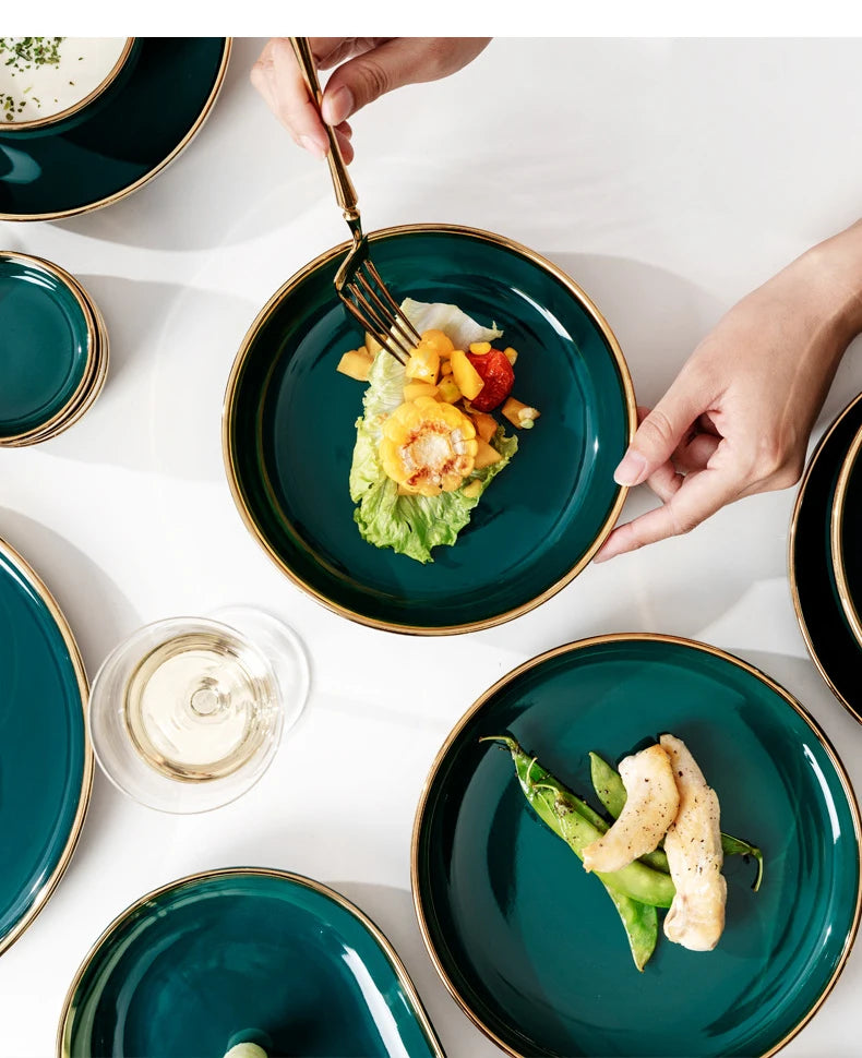 Dark green ceramic cutlery bowls set with gold-plated accents, featuring rice bowls and porcelain dishes for kitchen use.