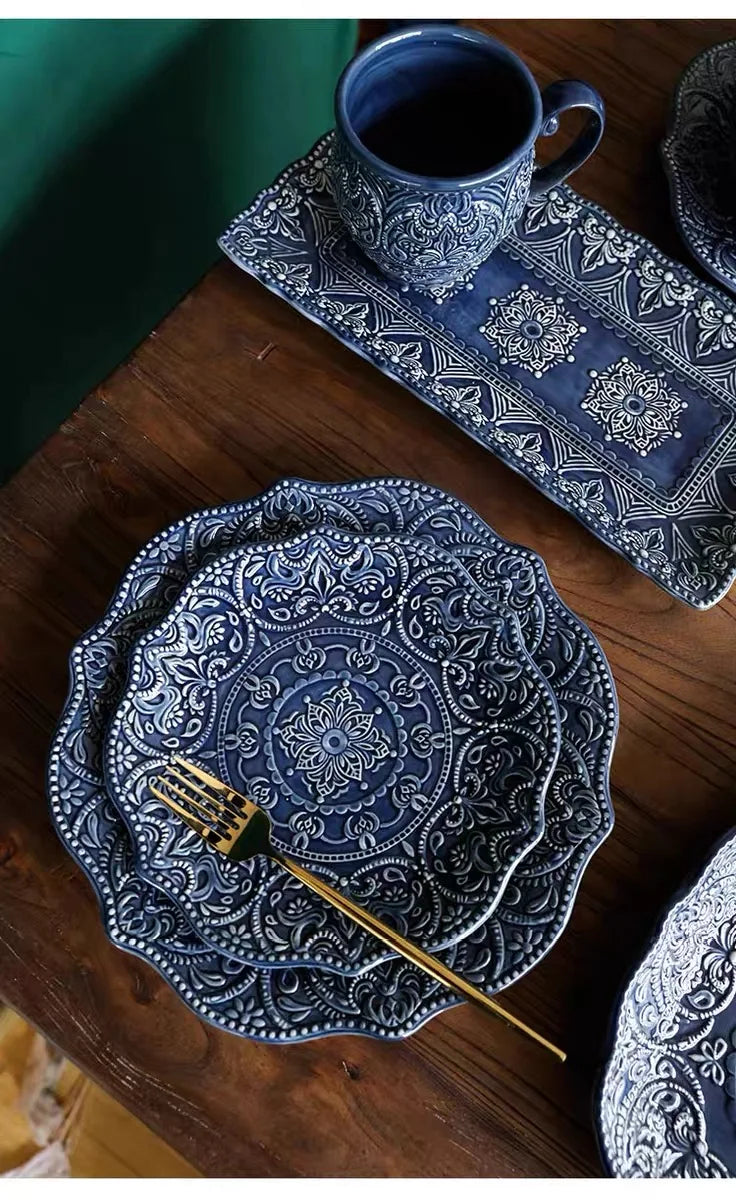 Blue retro relief ceramic dinnerware set by MC The Black Diamond, featuring multiple matching dishes with textured relief design.