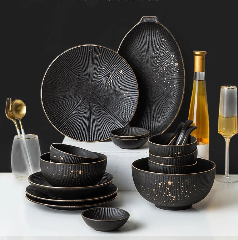 Luxury Golden Black Tableware Set by MC THE BLACK DIAMOND, elegant dinnerware with gold accents and a sleek black finish, arranged on a table.