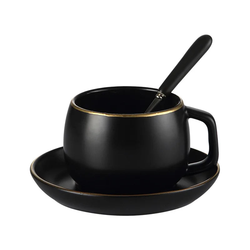 Matte black ceramic coffee cup with gold border and matching saucer, modern design by 𝕄𝕔 𝕋𝕙𝕖 𝔹𝕝𝕒𝕔𝕜 𝔻𝕚𝕒