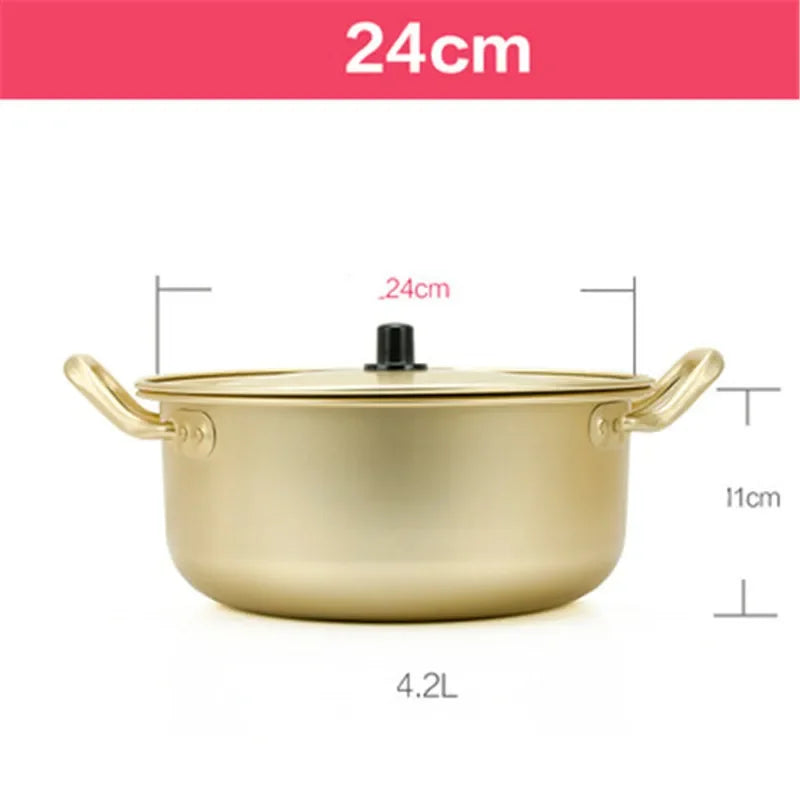 Gold aluminum stock pot from MC THE BLACK DIAMOND for hot cooking and kitchen use, with a sturdy handle and shiny finish.