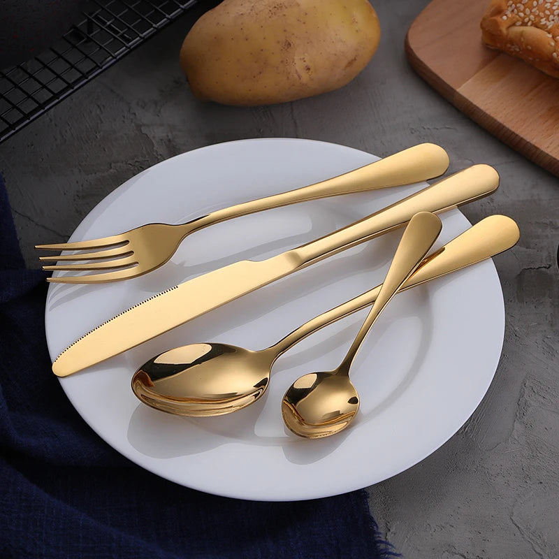 MC THE BLACK DIAMOND golden flatware set with cutlery dishes, featuring sleek and elegant silverware for dining.