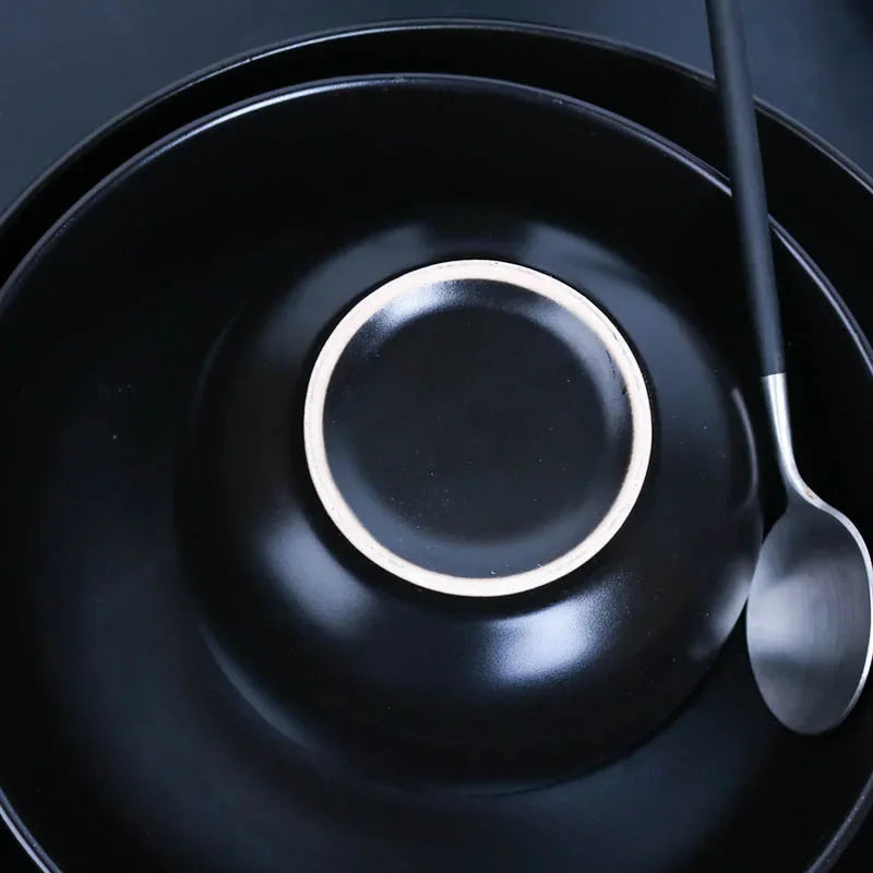 Deep black family dinner set by MC THE BLACK DIAMOND, featuring matching dinner plates, bowls, and cups for elegant dining.