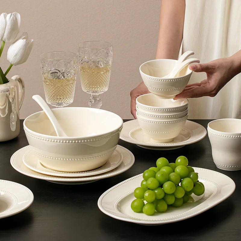 Modern minimalist ceramic dinnerware set with round plates and bowls, designed by MC THE BLACK DIAMOND for elegant table settings.