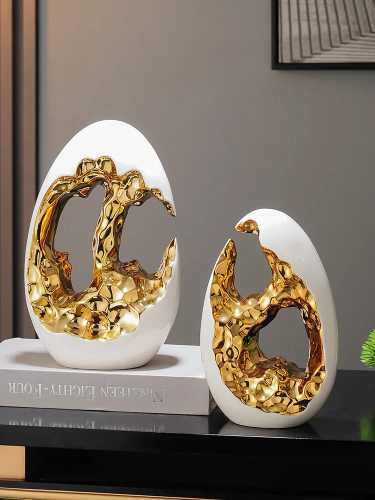 Gold figurines from MC THE BLACK DIAMOND for living room or office decor, displayed on TV cabinet or desktop.