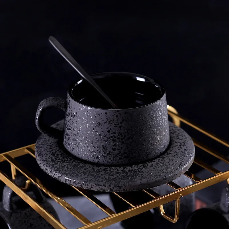 Black ceramic coffee cup and saucer set with spoon and cup holder, part of MC THE BLACK DIAMOND coffee and tea sets.