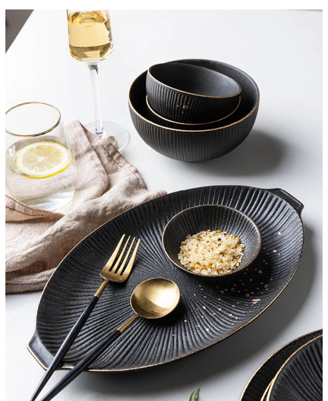 Elegant luxury golden and black dinnerware set by MC THE BLACK DIAMOND, featuring plates, bowls, and utensils arranged on a stylish table.