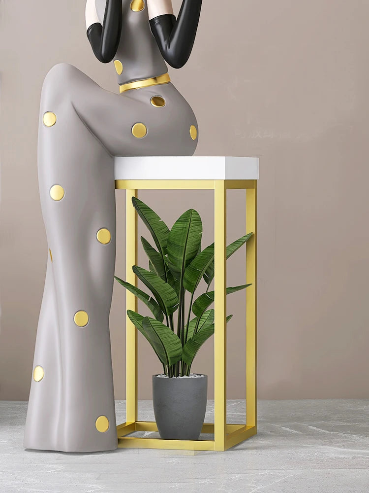Decorative figurines displayed on a tray in a living room foyer next to a TV cabinet, by MC THE BLACK DIAMOND.