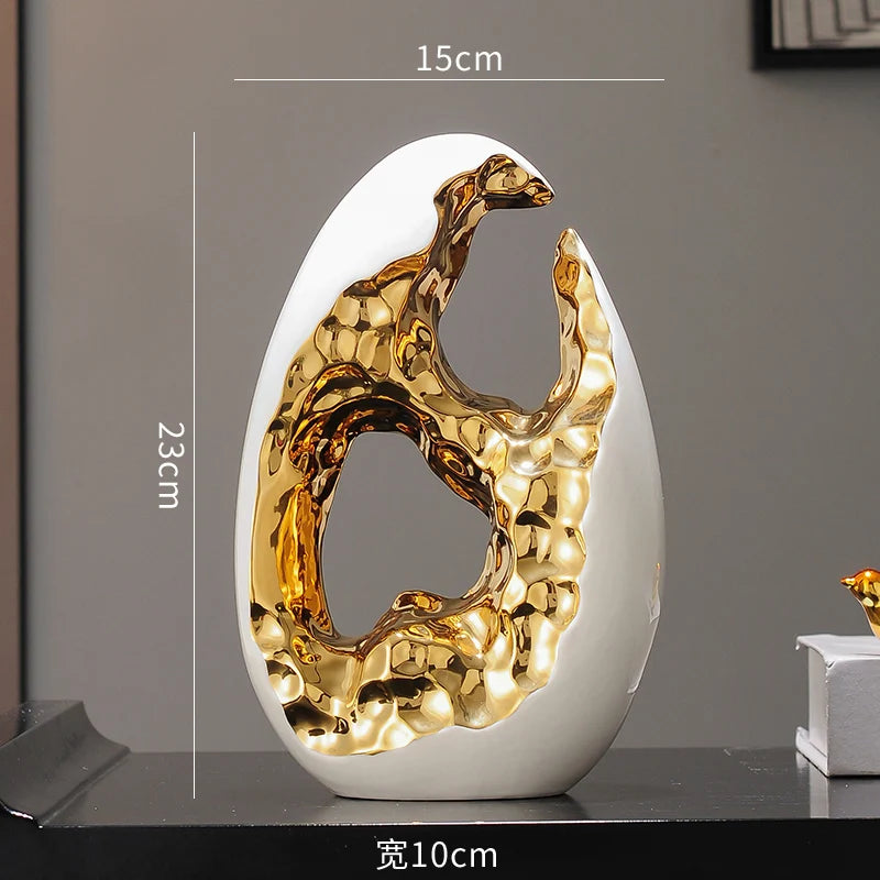 Gold figurines from MC THE BLACK DIAMOND decor collection, displayed on a living room TV cabinet and office desktop.