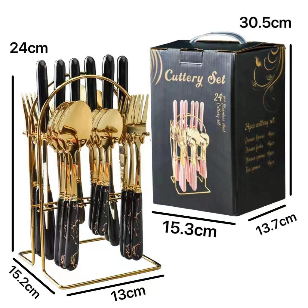 MC THE BLACK DIAMOND stainless steel cutlery set with knives, forks, and spoons arranged on a wooden table.