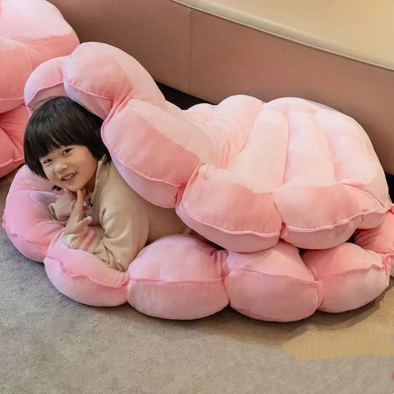 Large seashell-shaped plush pillow from MC THE BLACK DIAMOND, designed as a giant shuck cushion for kid beds and sofas.
