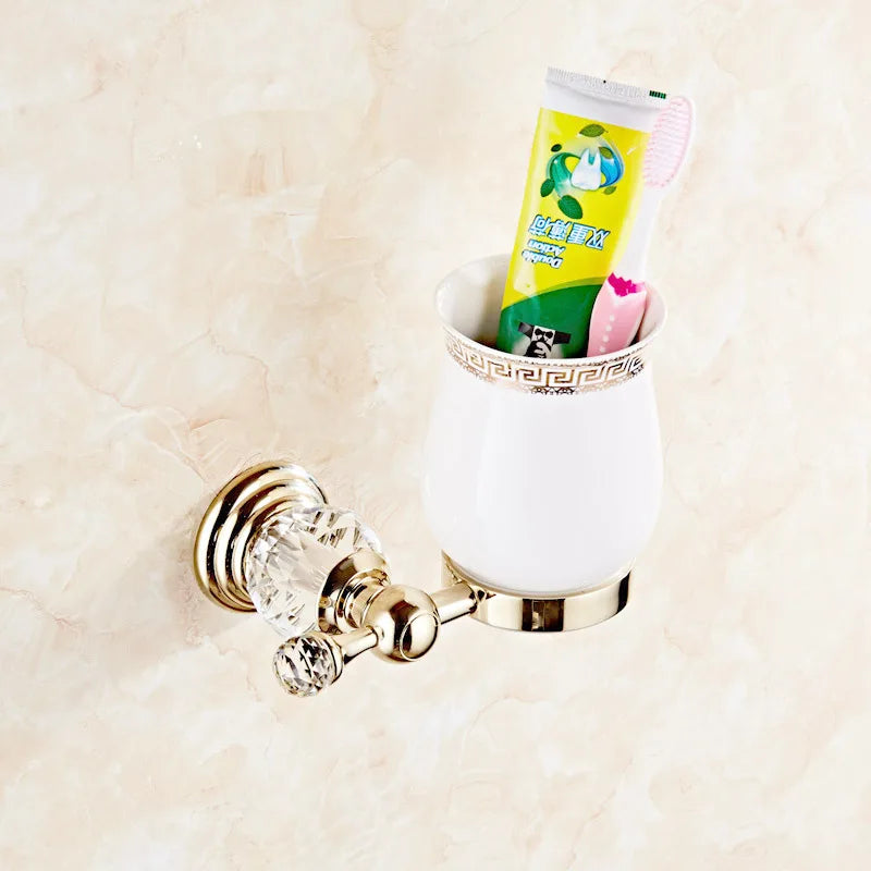 Luxury gold polished brass bathroom accessories set, including soap dish, tumbler, and towel ring, by MC THE BLACK DIAMOND.