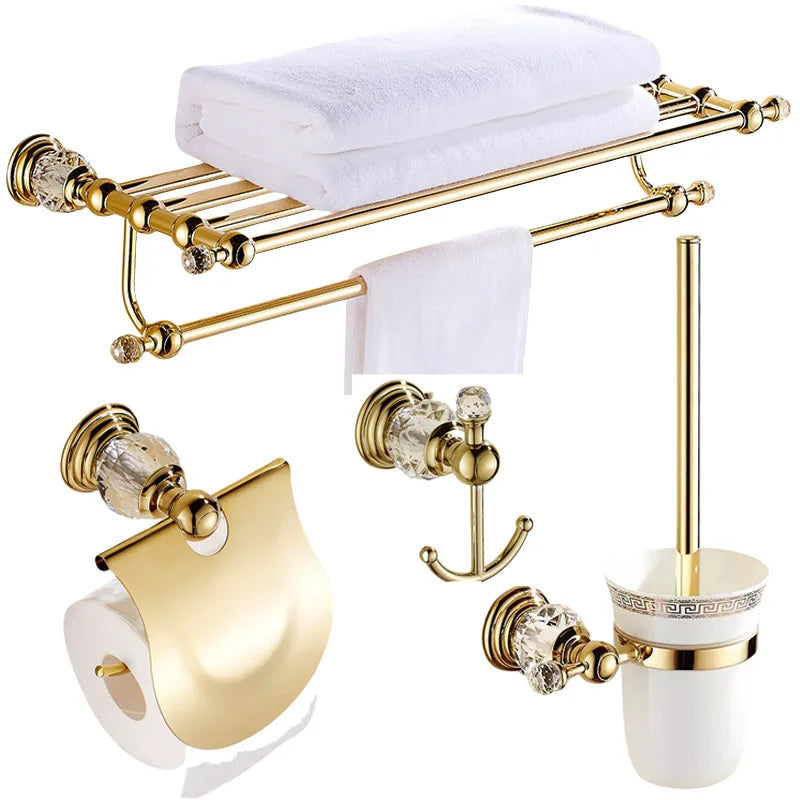 Luxury gold polished brass bathroom accessories set by MC THE BLACK DIAMOND, includes soap dispenser, toothbrush holder, and tumbler.