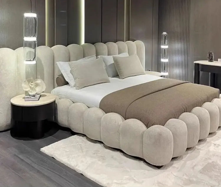 Large comfortable bed by MC THE BLACK DIAMOND featuring plush bedding and a cozy, inviting appearance.