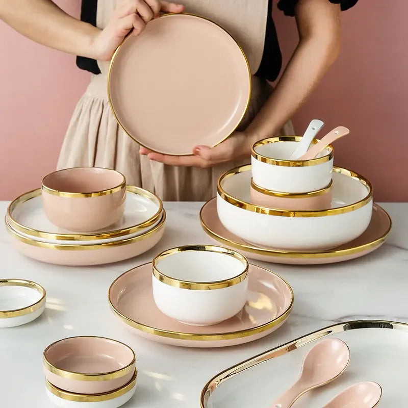 Bright white and pink porcelain plates set with gold accents, designed for elegant kitchen table settings by MC THE BLACK DIAMOND.