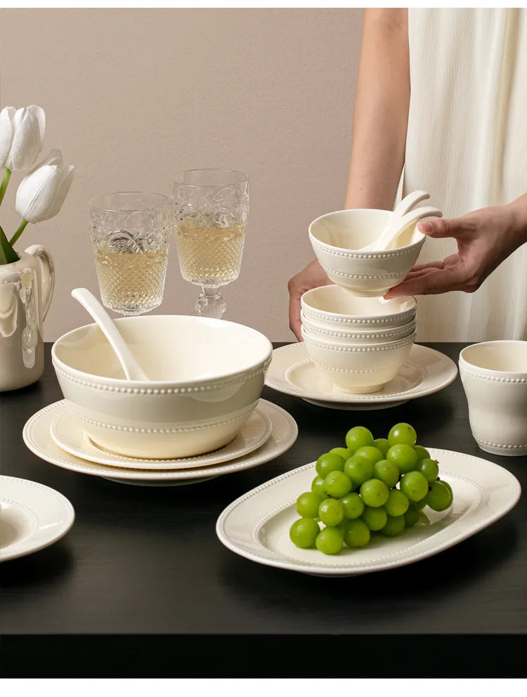 Modern minimalist ceramic round dinnerware set by MC THE BLACK DIAMOND, featuring sleek plates and bowls for stylish table setting.