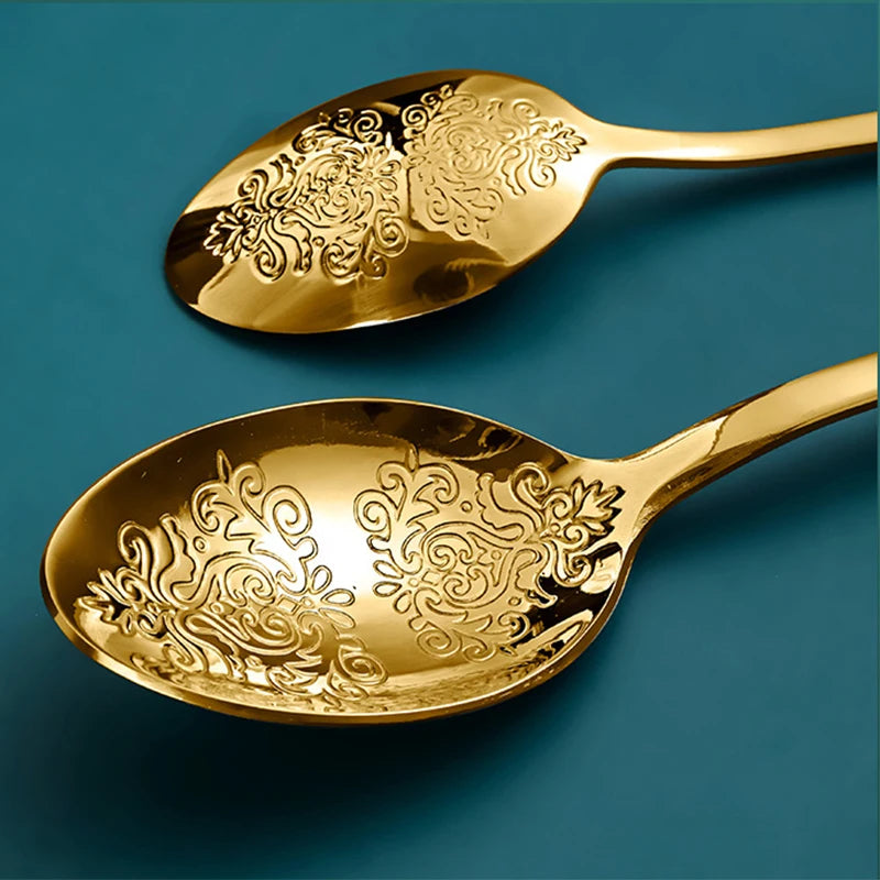 Stainless steel gold flatware set with forks, knives, and spoons from MC THE BLACK DIAMOND, arranged on a white background.