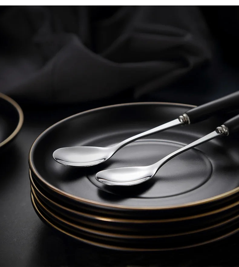 Creative matte black ceramic coffee cup with gold border and matching saucer, modern design for cafe or home use.