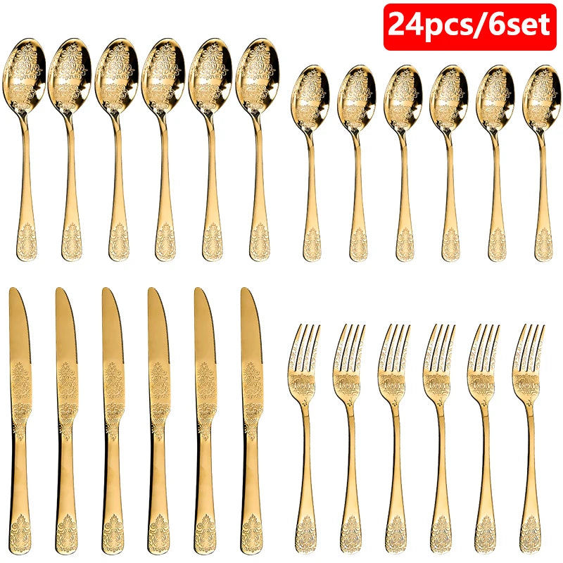 Stainless steel silverware set with gold finish from MC THE BLACK DIAMOND, includes forks, knives, and spoons arranged on a table.