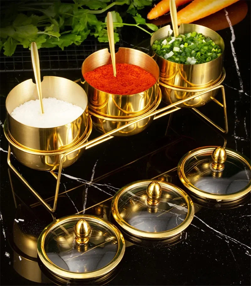 Golden seasoning box with glass cap, spoon, and flavoring tank from MC THE BLACK DIAMOND kitchen tools.