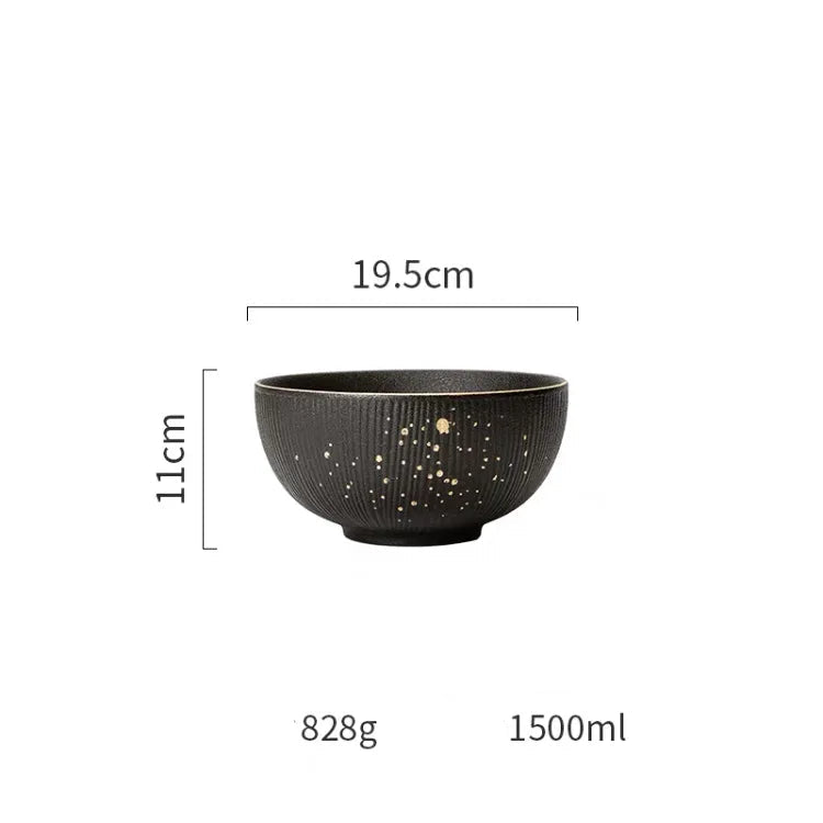 Luxury golden and black dinnerware set by MC THE BLACK DIAMOND, elegant tableware with plates and bowls on a stylish table.