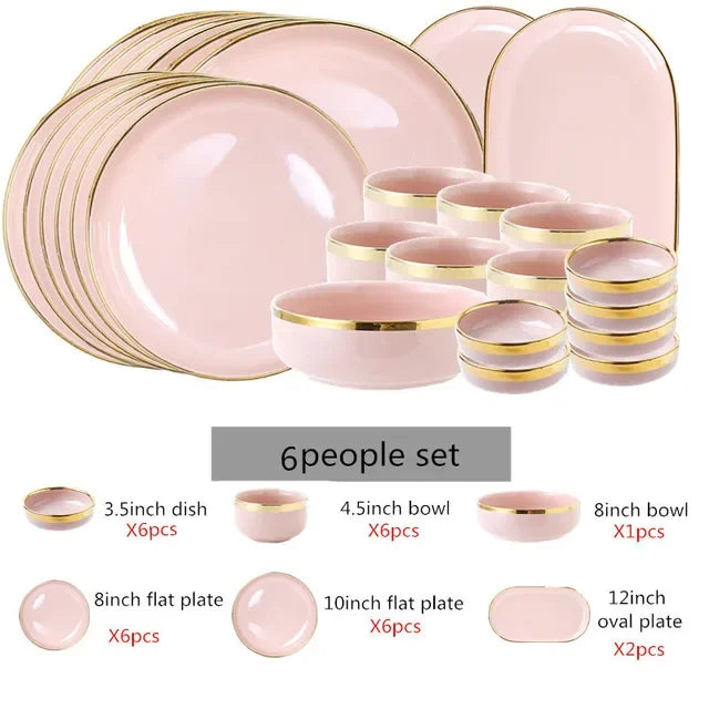 Bright white and pink porcelain plates set with gold accents by MC THE BLACK DIAMOND, arranged on a kitchen table.