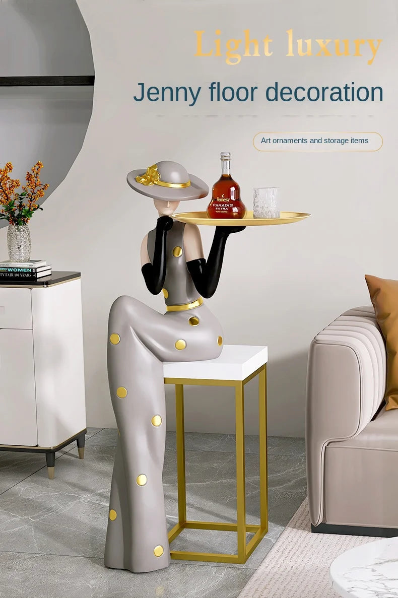 Decorative figurines from MC THE BLACK DIAMOND on a living room tray next to a TV cabinet and sofa.