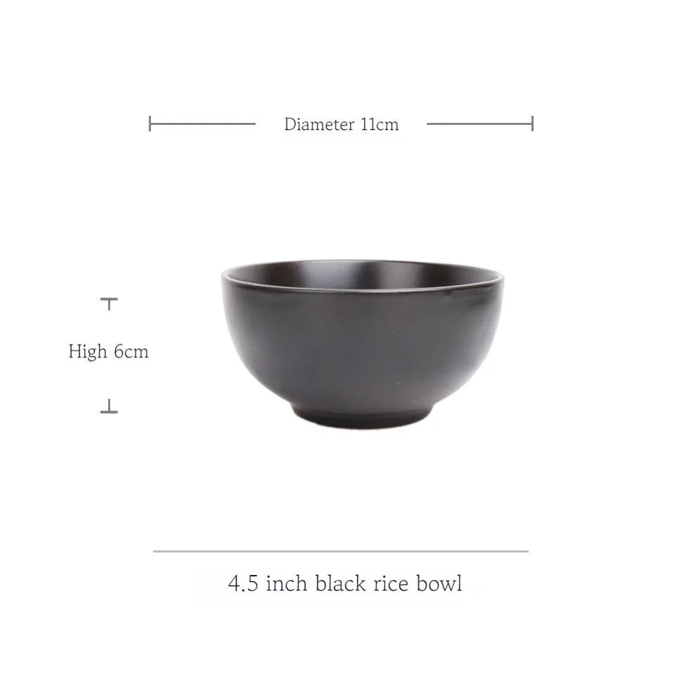 Deep black MC THE BLACK DIAMOND family dinner set with plates, bowls, and cups arranged on a table.
