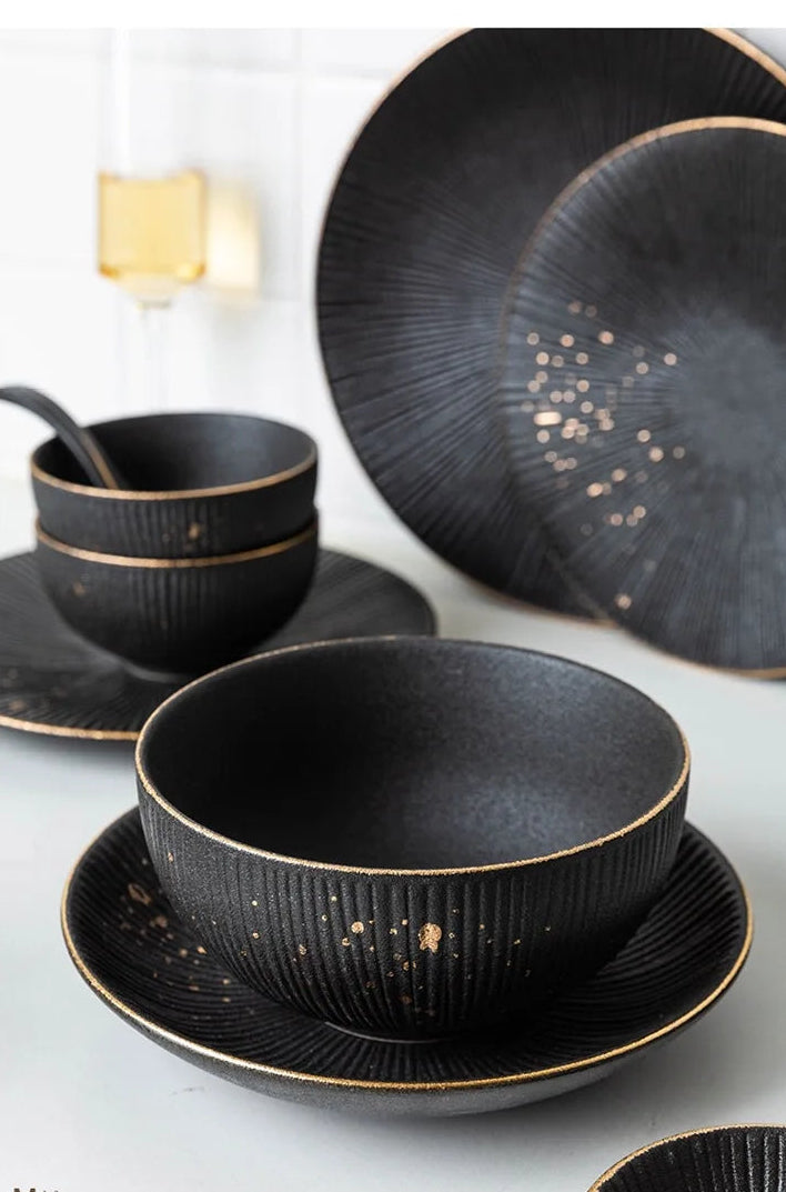 Luxury Golden Black MC THE BLACK DIAMOND dinnerware set with elegant plates and bowls, showcasing a sophisticated black and gold design.