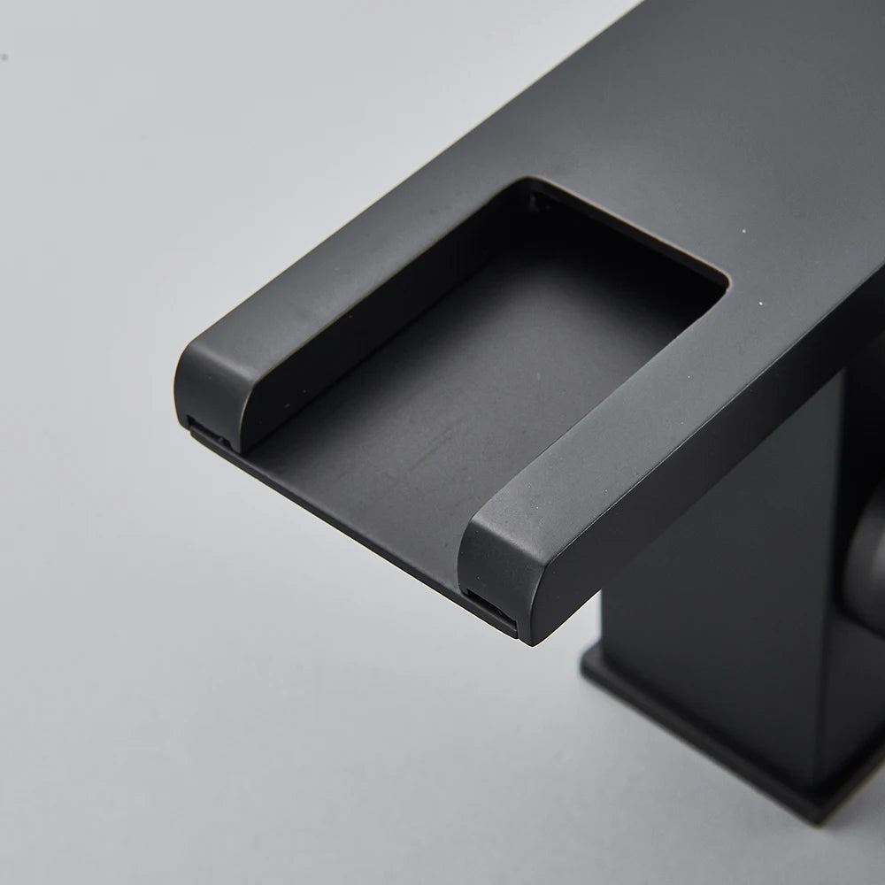 Black LED bathroom sink faucet by MC THE BLACK DIAMOND with brass waterfall design, hot and cold mixer for modern bath sinks.