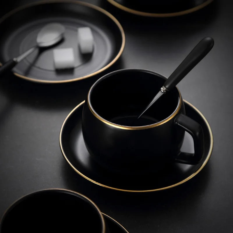 Creative matte black ceramic coffee cup with gold border and matching saucer, modern restaurant and cafe teacup set.