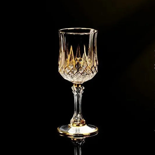 Elegant glass gold crystal red cup from MC THE BLACK DIAMOND drinkware set, showcasing its shiny gold accents and vibrant red design.