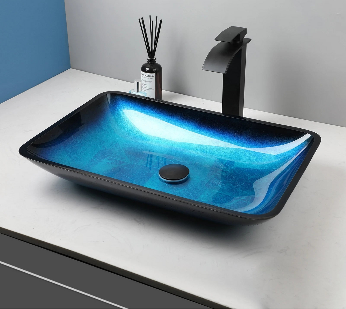Blue glass vessel sink with waterfall faucet set by MC THE BLACK DIAMOND, showcasing sleek design and modern bathroom fixture.